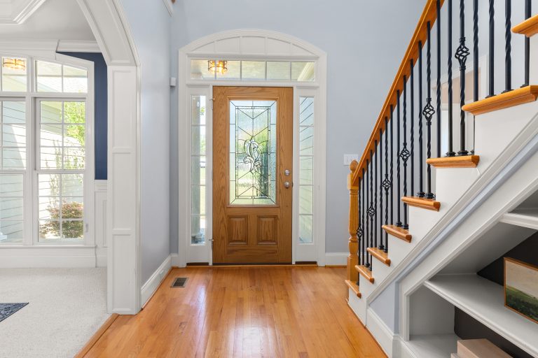 Oak stair treads with iron balusters above a hardwood entry floor in a Tennessee home