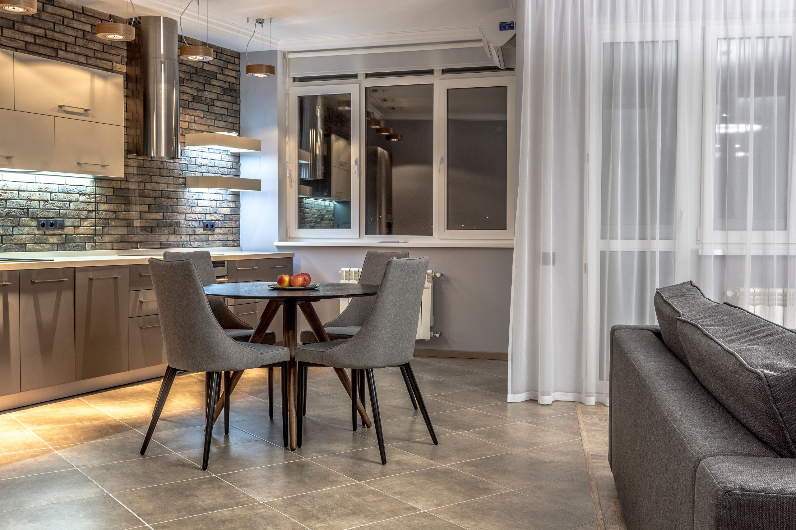 Large stone-look tile flooring in a Tennessee kitchen and dining area