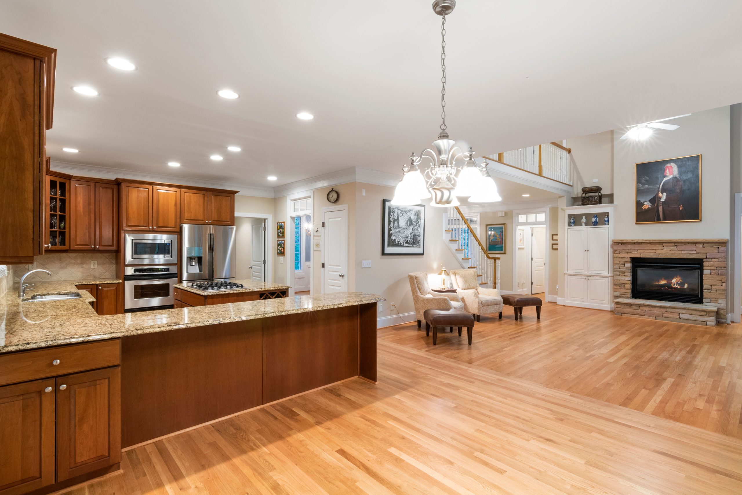 Warm oak flooring running from a Tennessee kitchen through to a great room with a fireplace