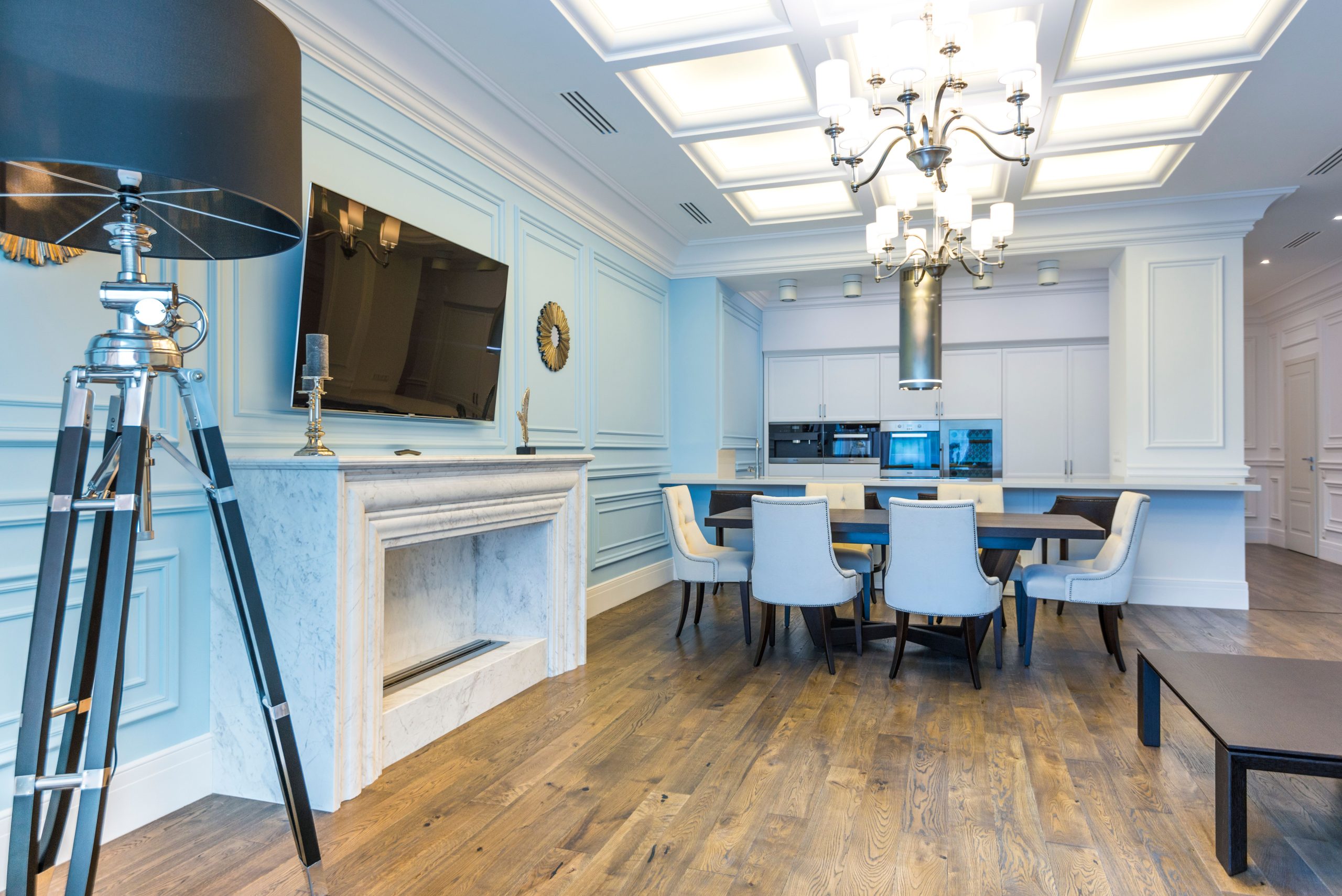 Wide-plank wood flooring in a Tennessee living and dining room with a stone fireplace